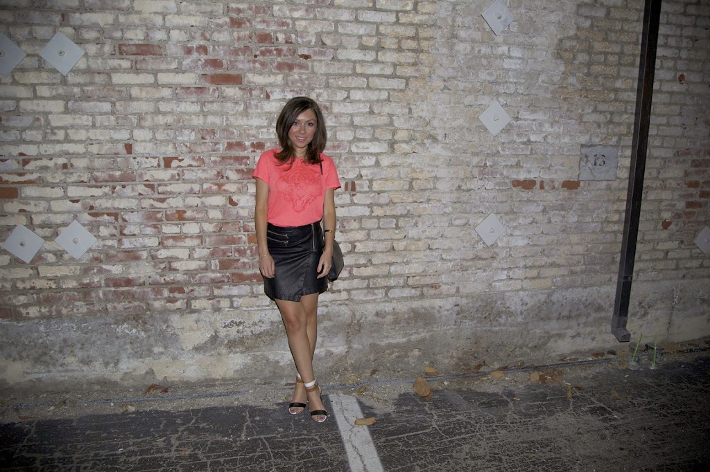 Blogger Nihan showing her trendy outfit - orange t-shirt, leather skirt and high-heels in Downtown La Jolla