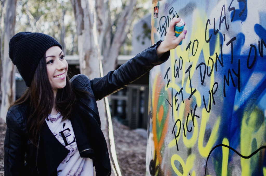 Model painting a graffiti wall