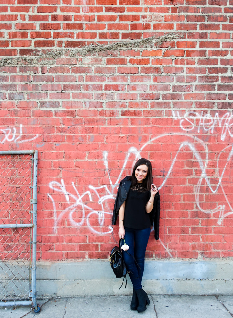 Nihan wearing black leather jacket, blue jeans and lace black top in DTLA