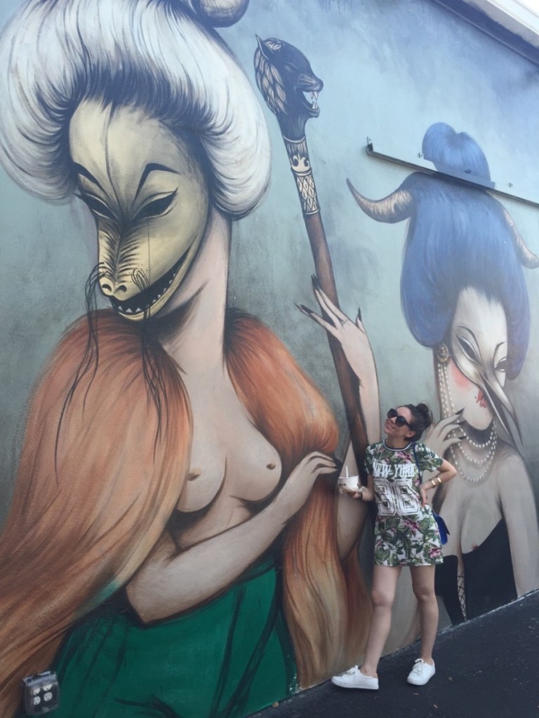 Nihan in front a Miss Van mural in Wynwood Walls, Miami